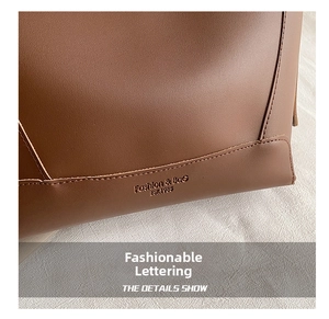 Detail of vintage brown leather bucket bag showing precise stitching and logo lettering