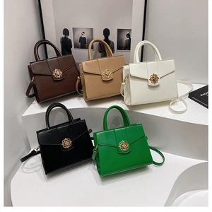 Detailed display of vintage tote bags in five colors with golden flower metal clasps