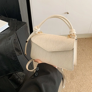 Chic cream white textured lace shoulder bag with knotted handle and elegant flap closure
