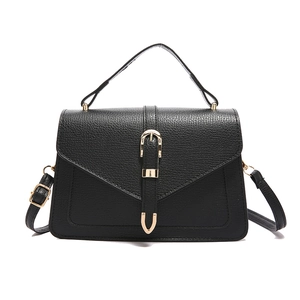 Minimalist black pebbled leather tote bag with gold metal buckle and top handle