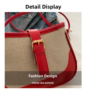 Detail view of woven canvas and red leather handbag with gold metal buckle