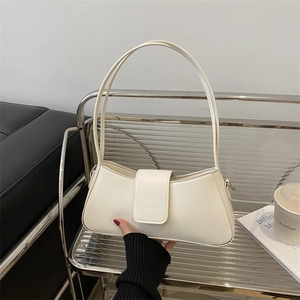 Chic beige baguette underarm bag with slim double handles for stylish women commuting