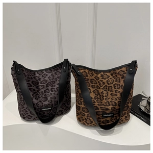 Detail view of large leopard print bucket bags in brown and grey with black straps