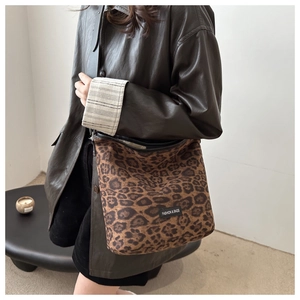 Close-up of leopard print shoulder bag with detailed fashion and bags logo label