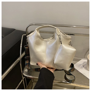Detail of pearl white tote bag with bohemian shoulder strap and matching mini pouch
