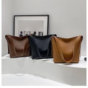 Detailed comparison of vintage leather bucket bags in dark brown, black, and caramel colors