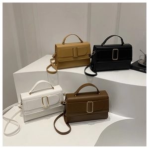 Chic square crossbody bag with metallic buckle in four colors displayed on white pedestals