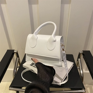 Minimalist white structured crossbody handbag with top handle and sleek shoulder strap