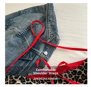 Detail of red fabric shoulder strap and leopard print canvas tote bag close-up
