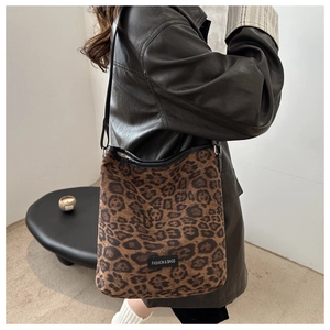 Detail of leopard print tote bag with black leather strap and Fashion & Bags label
