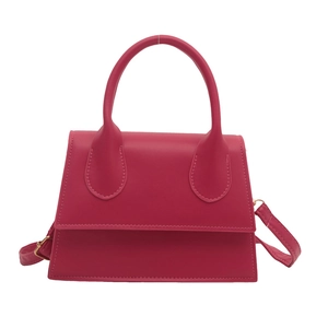 Retro fuchsia square handbag with large circular handle and adjustable shoulder strap