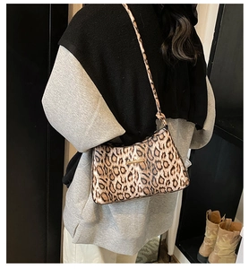 Detail of leopard print shoulder bag featuring gold-tone metal hardware and retro texture