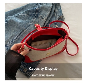 Detail view of red and beige shoulder bag interior space showing ample storage capacity