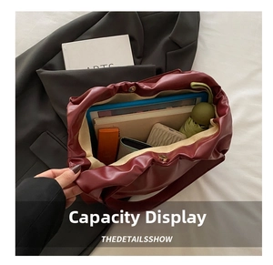 Deep red soft leather tote bag showing large capacity for umbrella and notebooks