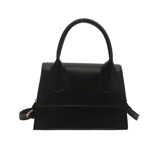 Classic black leather-style trapezoid handbag with rounded handle and adjustable strap