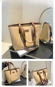 Détail d'un sac cabas kaki et marron avec patch cuir dans un intérieur moderne