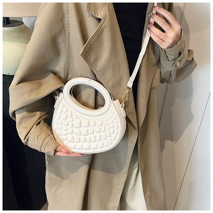 White faux leather crescent bag with crocodile pattern and round cutout handle