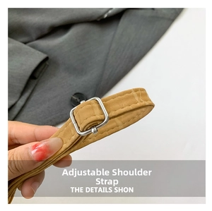Detail of adjustable camel faux crocodile leather strap with silver metal buckle