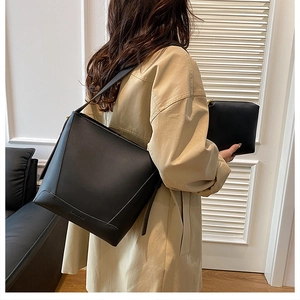 Minimalist black matte leather bucket bag set with matching inner pouch for women