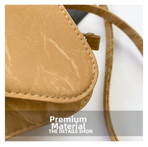 Detail of premium brown faux leather bag with precision stitching and flap structure