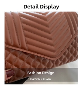 Close-up of brown leather crossbody bag featuring intricate V-shaped quilted texture