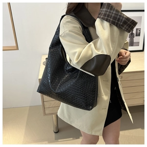 Detail of black woven leather hobo bag with classic intrecciato texture and large capacity