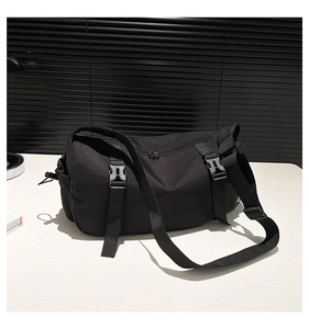 Detail of durable black nylon crossbody bag with adjustable buckles and side pocket