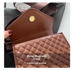 Close-up of golden magnetic snap button on brown quilted leather crossbody bag