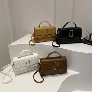 Minimalist solid color small square bags in four colors on a tiered display stand