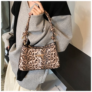 Chic leopard print baguette bag featuring knotted shoulder strap and gold metal bar detail