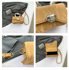 Detail of yellow pleated handbag with liquid metal handle and magnetic closure