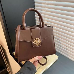Sac à main minimaliste en cuir marron foncé avec boucle dorée et longue bandoulière