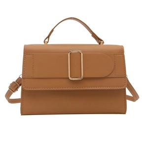 Minimalist camel crossbody bag with gold hardware and top handle on white backdrop