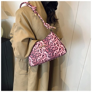 Detail of pink leopard print shoulder bag with faux horsehair texture and gold hardware