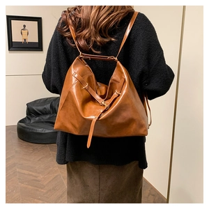 Brown vintage large leather tote bag shown worn as a versatile shoulder bag for women