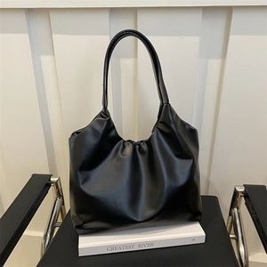 Minimalist black tote bag in smooth faux leather with gathered pleated details for daily commute