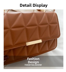 Detail of caramel quilted crossbody bag featuring geometric stitching and gold metal buckle