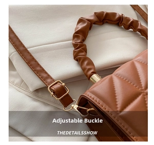 Detail of brown quilted bag showing ruched handle and adjustable metallic buckle strap