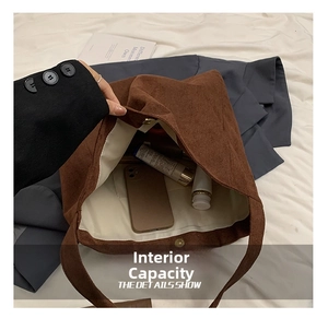 Detailed view of the brown corduroy tote bag interior with magnetic snap and pocket