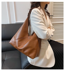 Minimalist brown leather tote bag with geometric stitching details for daily commute