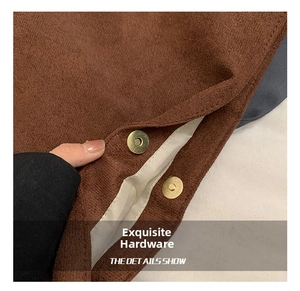 Detail of golden magnetic clasp on brown corduroy tote bag with durable lining