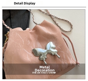 Detailed shot of pink faux leather bucket bag with metallic silver butterfly hardware