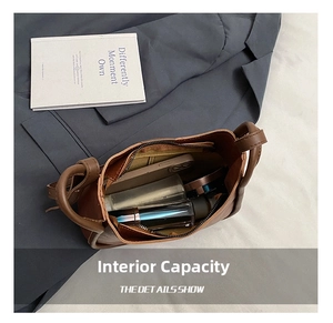 Interior view showing large capacity and zipper pocket of brown leather shoulder bag