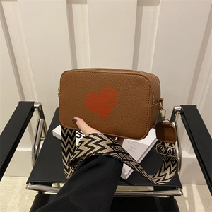 Brown lychee leather crossbody bag with red heart print and wide geometric strap
