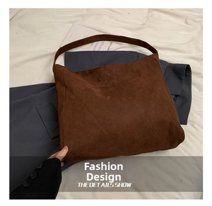 Detail view of large brown faux suede hobo shoulder bag with a wide strap design