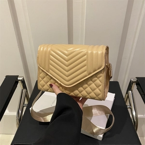 Chic beige quilted crossbody bag with stylish wide shoulder strap and flap design