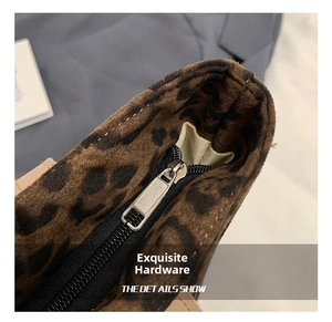 Close-up of high-quality silver zipper and leopard print fabric detail on tote bag