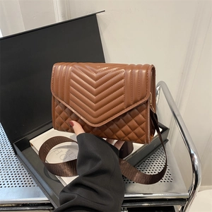 Vintage brown quilted crossbody bag with classic V-flap design and wide textile strap