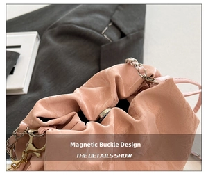 Detail view of pink bucket bag featuring a secure magnetic snap button closure