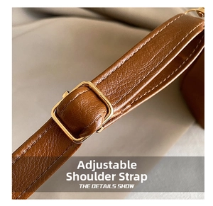 Macro detail of adjustable brown leather strap with golden buckle on bucket bag